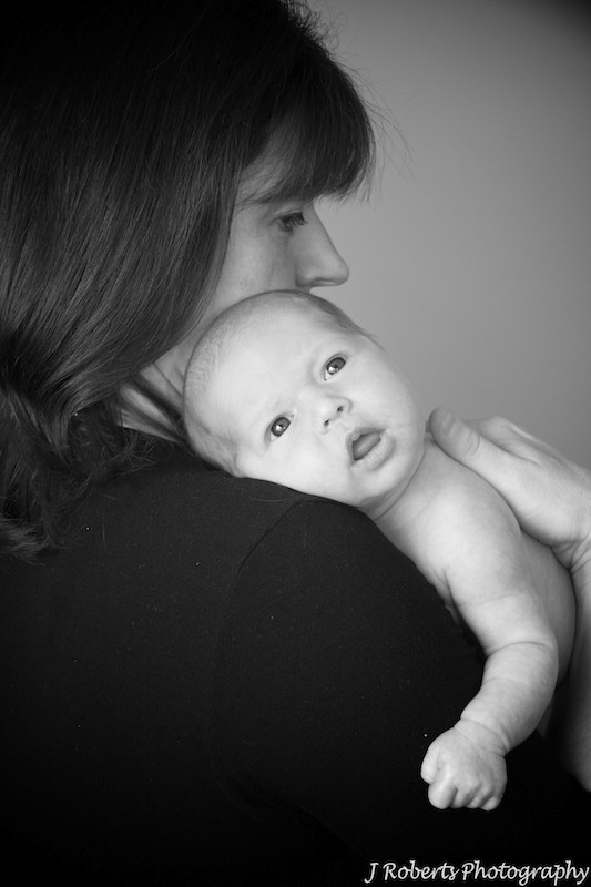 Baby on mothers shoulder - newborn portrait photography